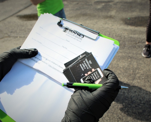 close up of a clipboard and promotional stickers at a Bernie's Book Bank event in Trier Township
