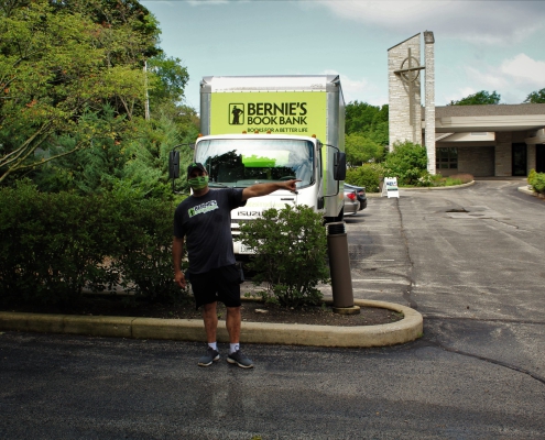a volunteer directs traffic at a Bernie's Book Bank donation event in Trier Township