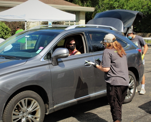A Trier Township volunteer talks to a book donor