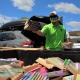 a volunteer sorts books into a massive bin