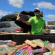 a volunteer sorts books into a massive bin