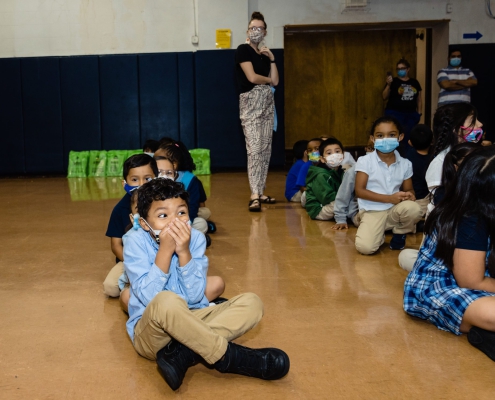a child covers his face with excitement
