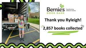 pictured: Ryleigh stands outside a truck of donated books - text: Thank you Ryleigh! 2,857 books collected