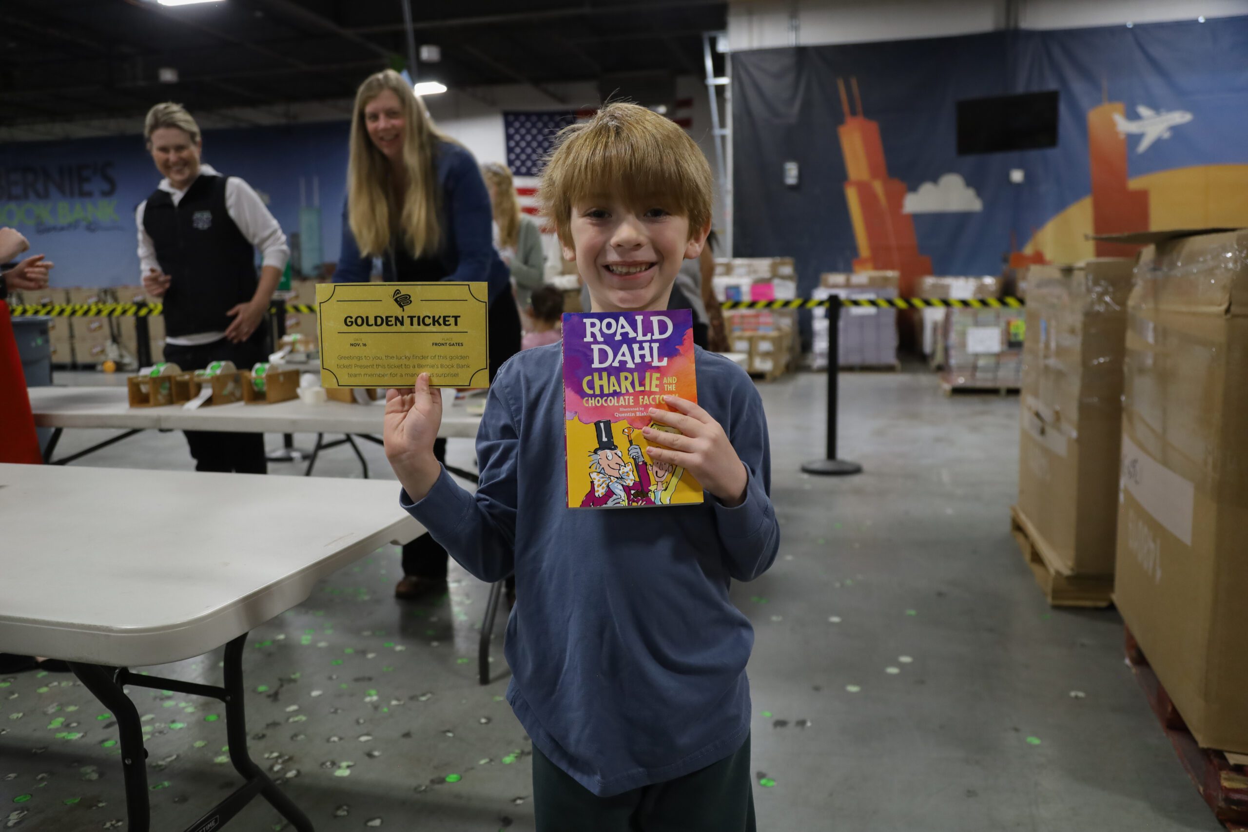 a child happily holds a Roald Dahl book at Bernie's Booksgiving event