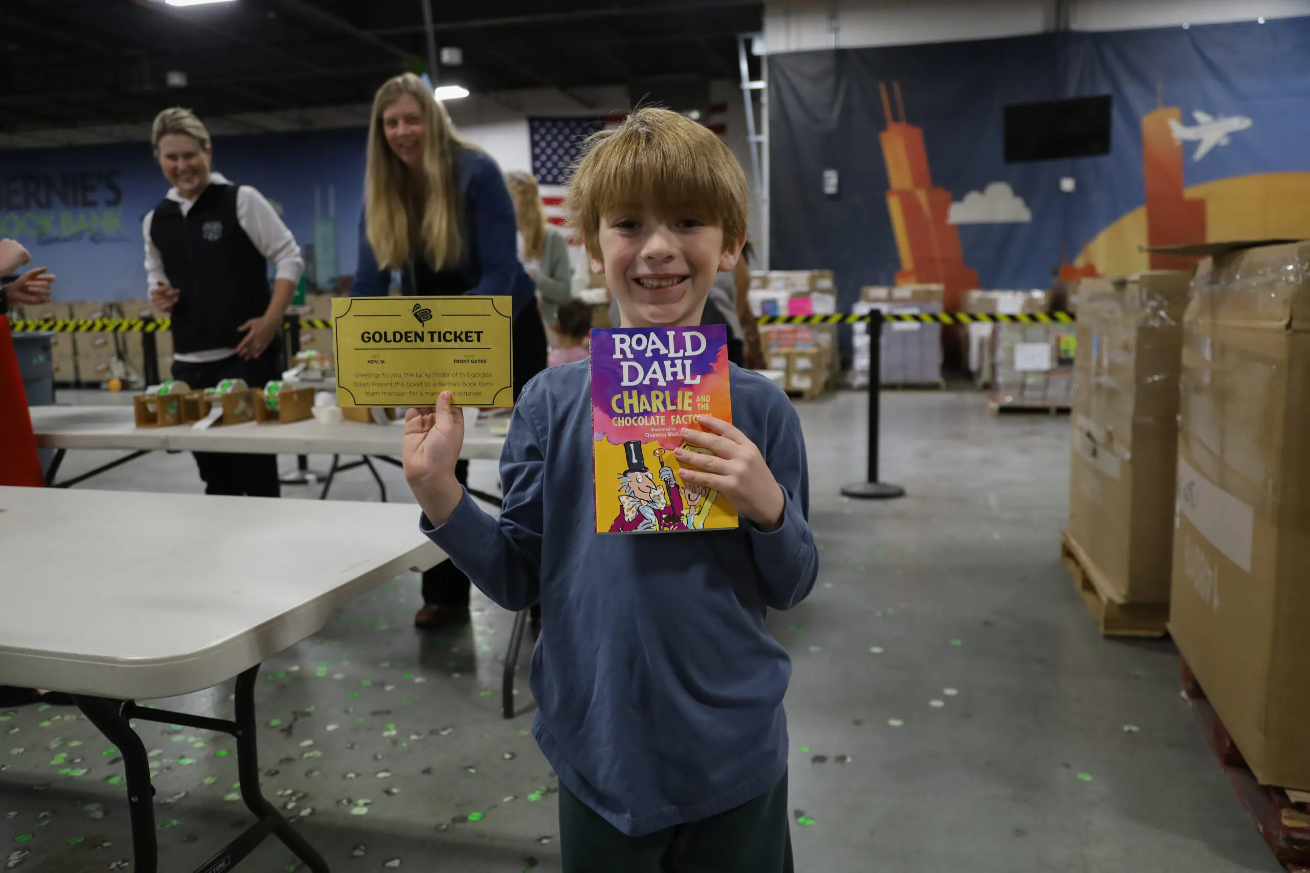 a child happily holds a Roald Dahl book at Bernie's Booksgiving event