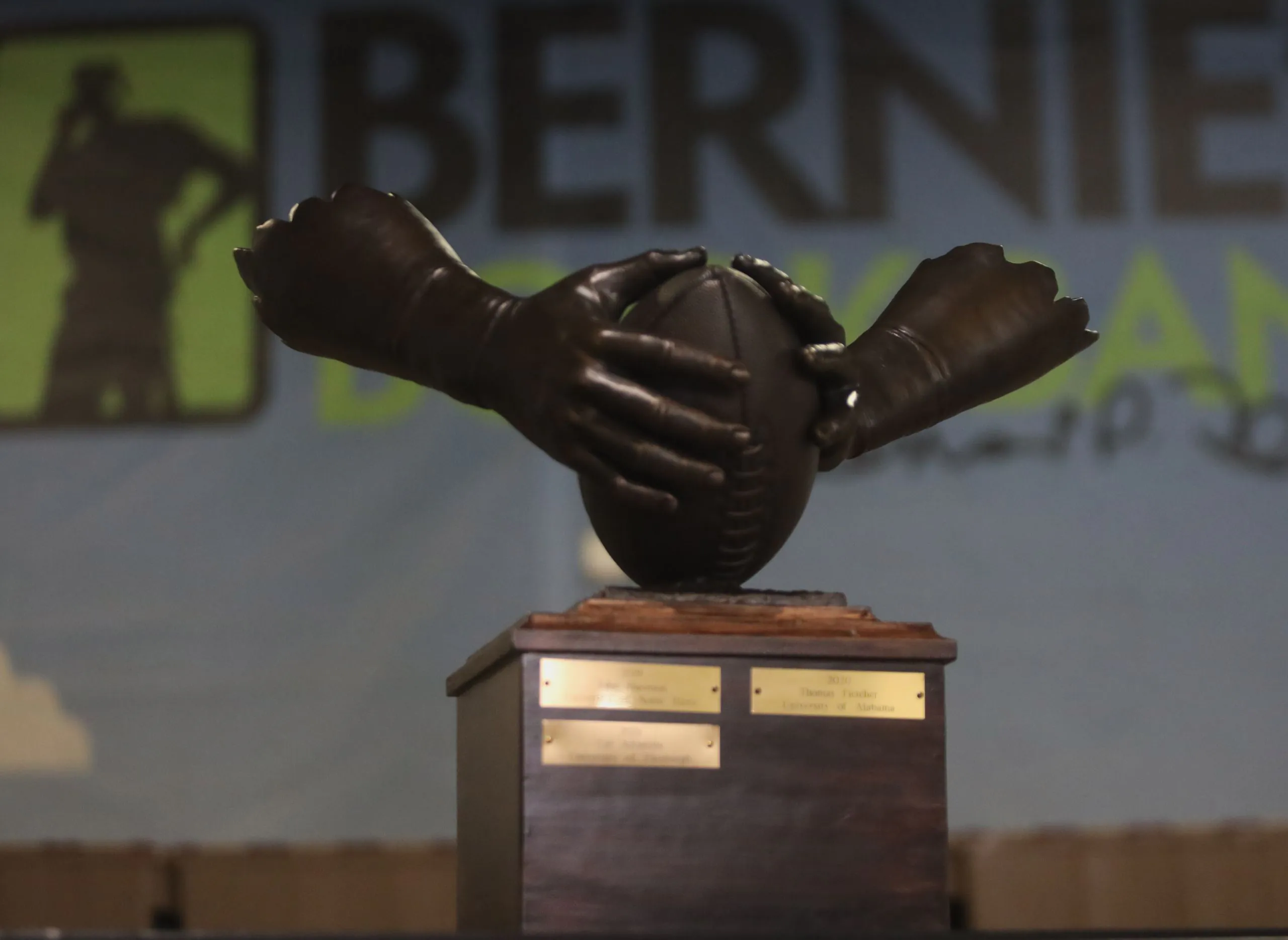 the Patrick Mannelly Award: two bronzed hands clasp a football