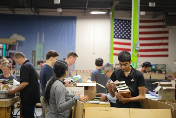 volunteers box up and sort donated books