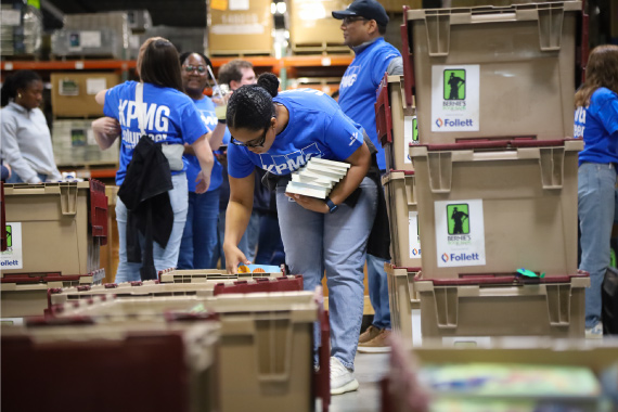 a Volunteer packs books into large bins