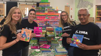 Zebra Technologies volunteers smile and organize books