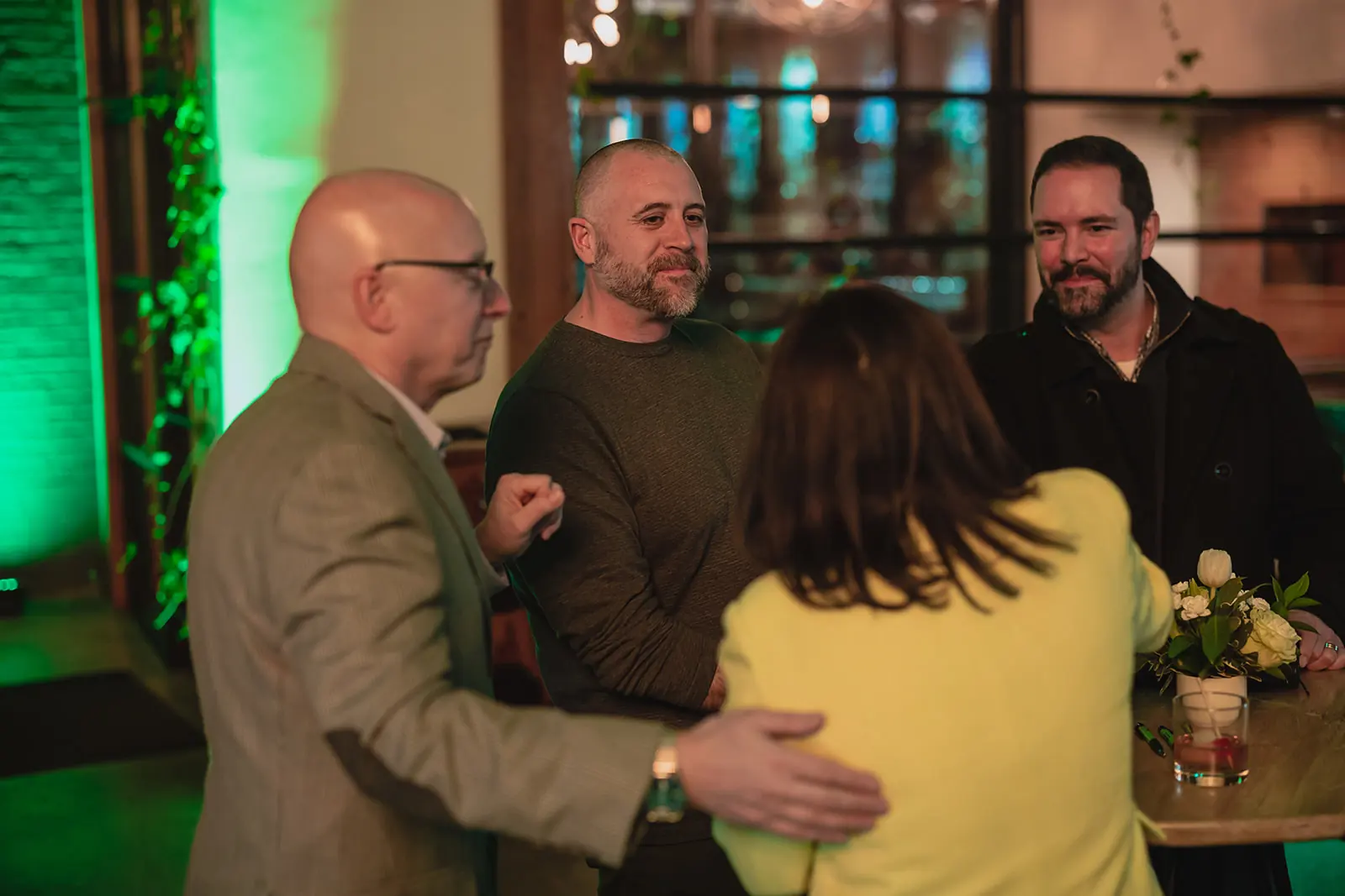 four attendees conversate at a Bernie's Book Bank fundraiser
