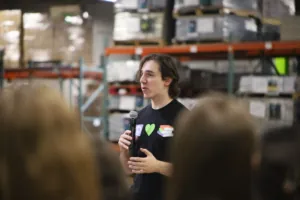 a volunteer leader speaks at a handheld microphone
