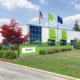 exterior photo of the new Bernie's Book Bank facility in Milwaukee, featuring a well-kept front lawn and green flags