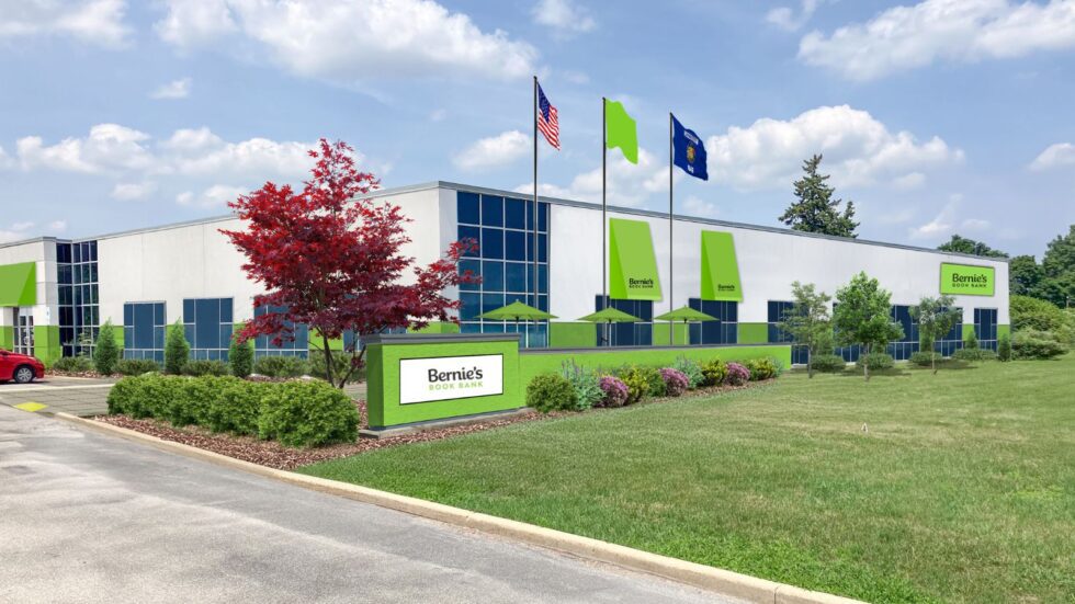 exterior photo of the new Bernie's Book Bank facility in Milwaukee, featuring a well-kept front lawn and green flags