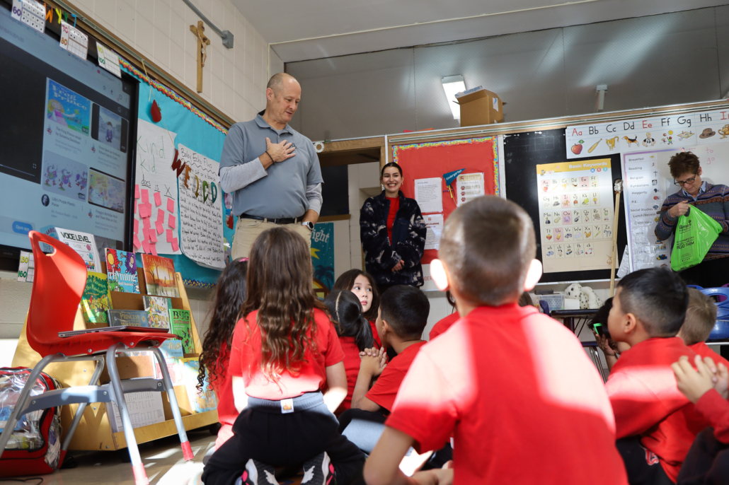 A Bernie's Book Bank team member speaks to a classroom of kids