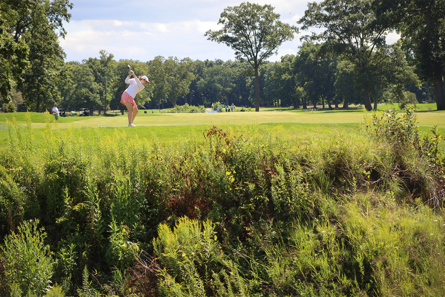 Person taking a shot down the fairway at the Bernie's Cup golf event