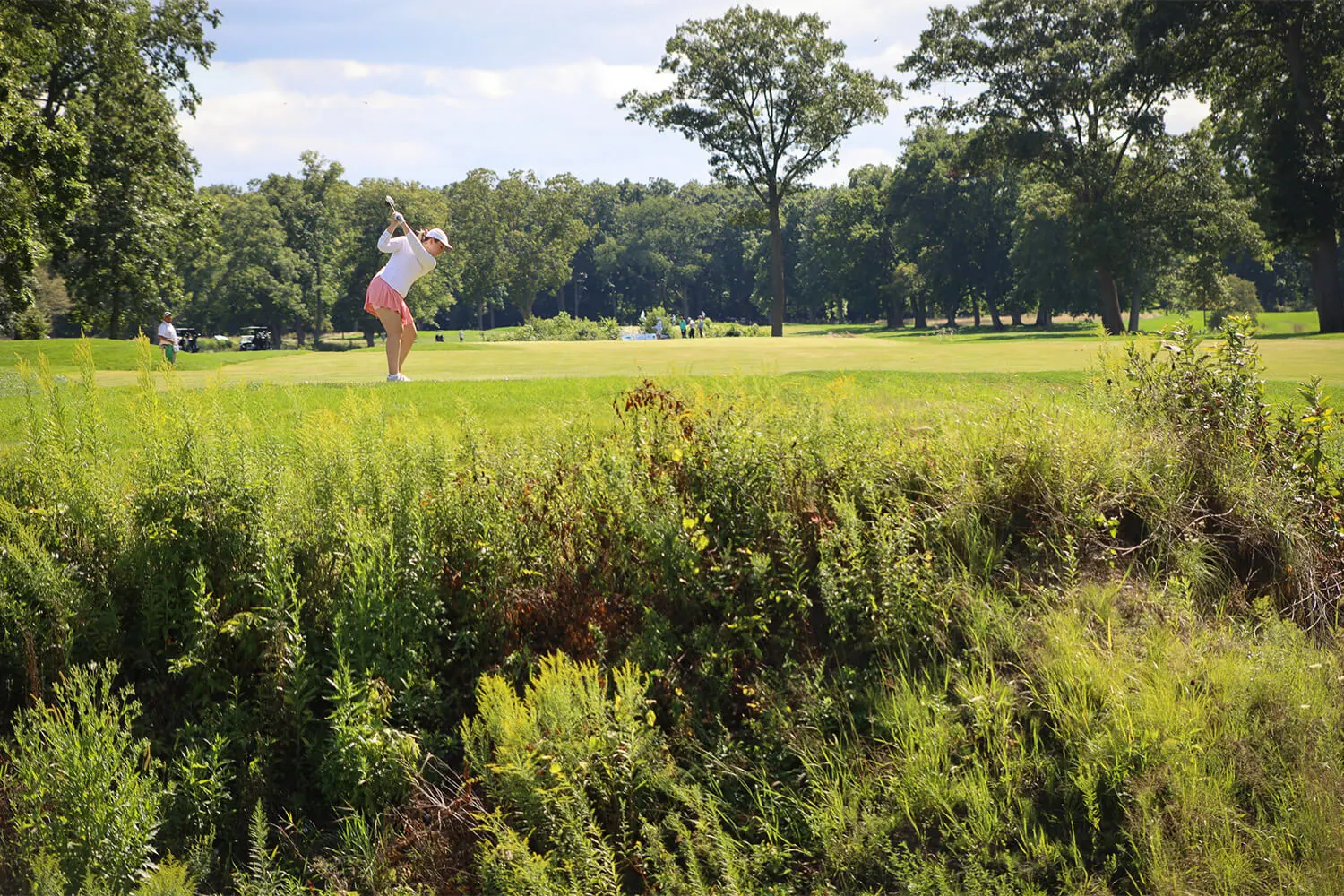 Person taking a shot down the fairway at the Bernie's Cup golf event