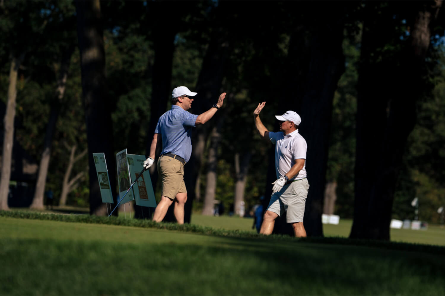 Player giving each other a high five at the Bernie's Cup golf event