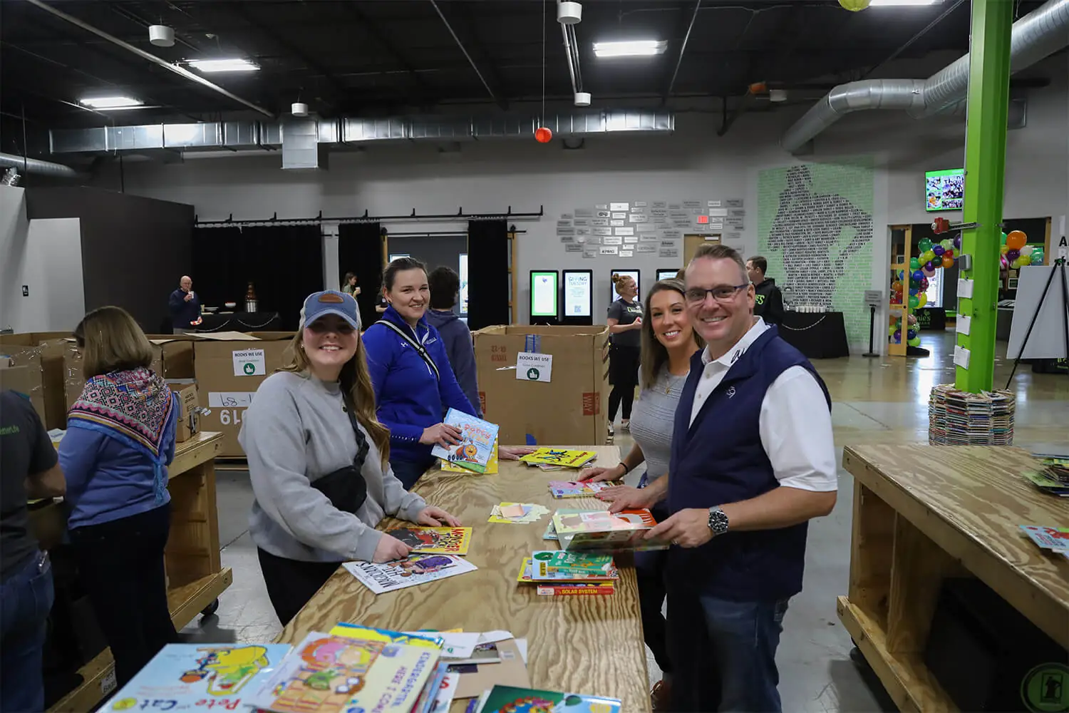 Group of people smiling at the camera at a book giving event