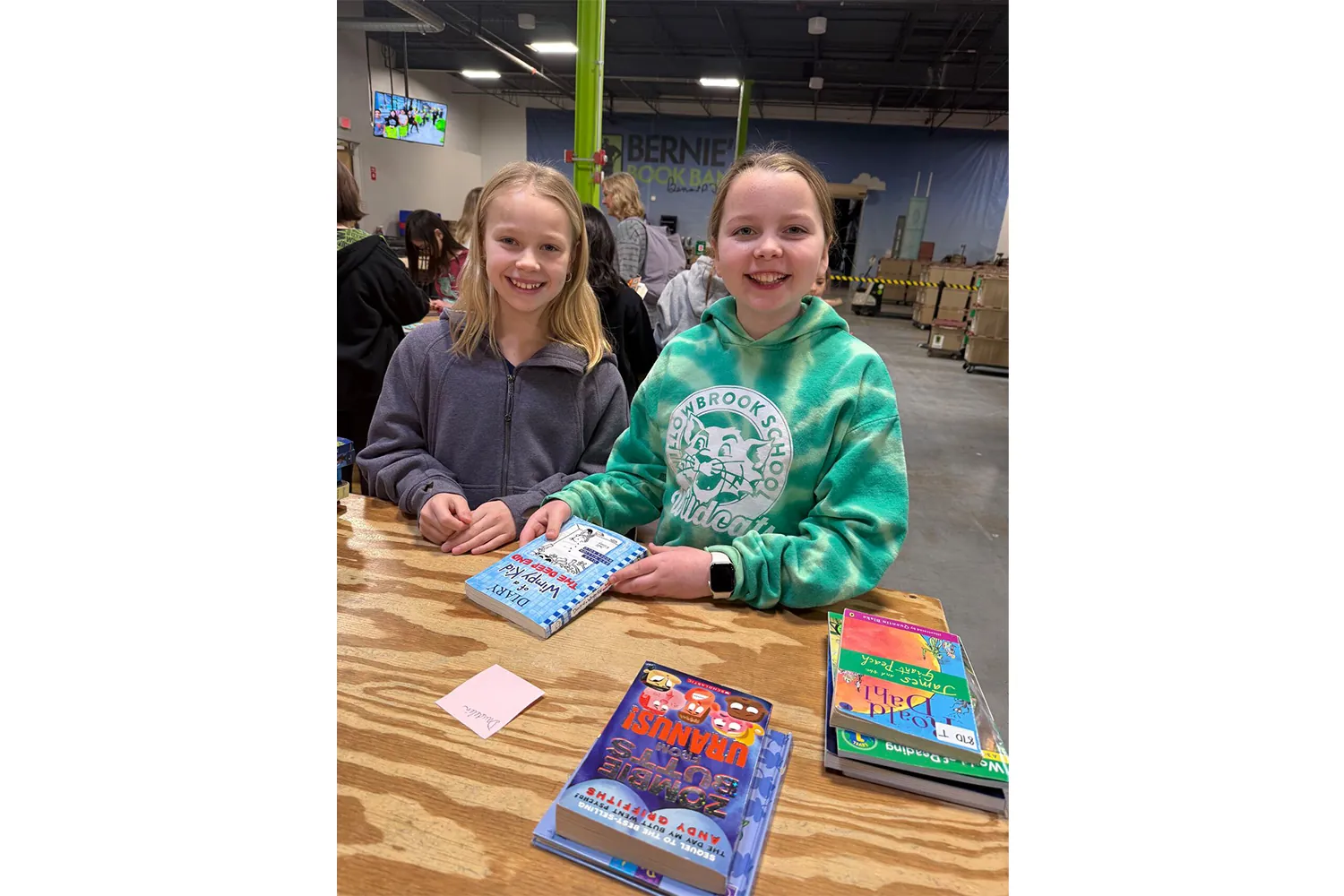 Two kids at a book giving event