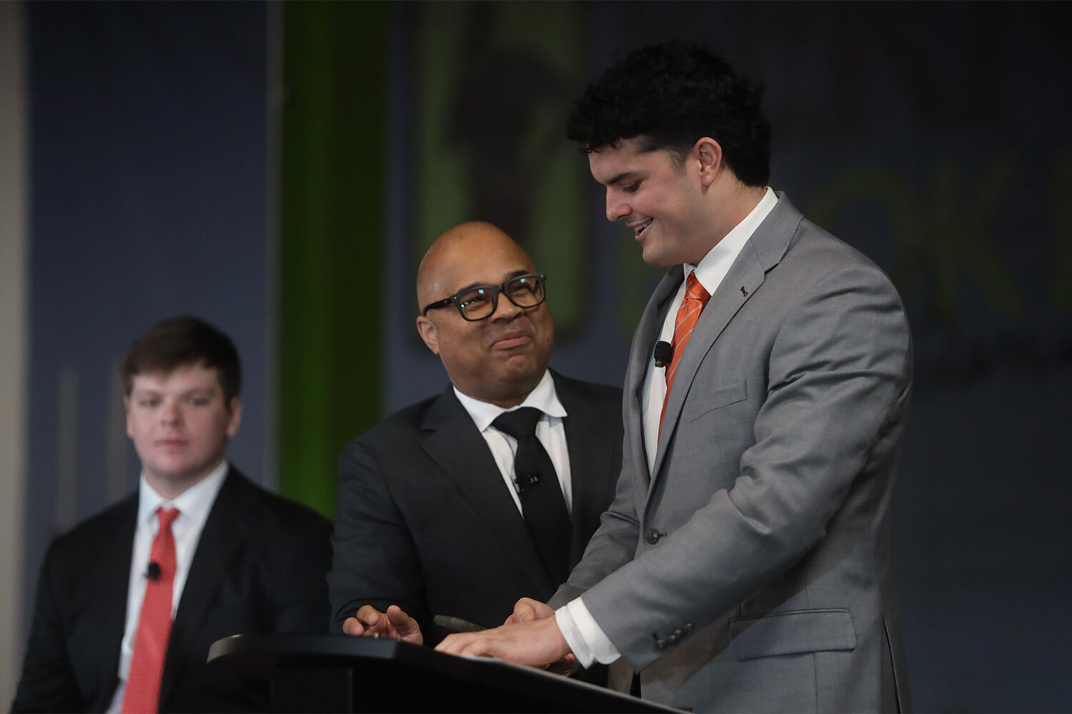 Individual standing at a podium speaking