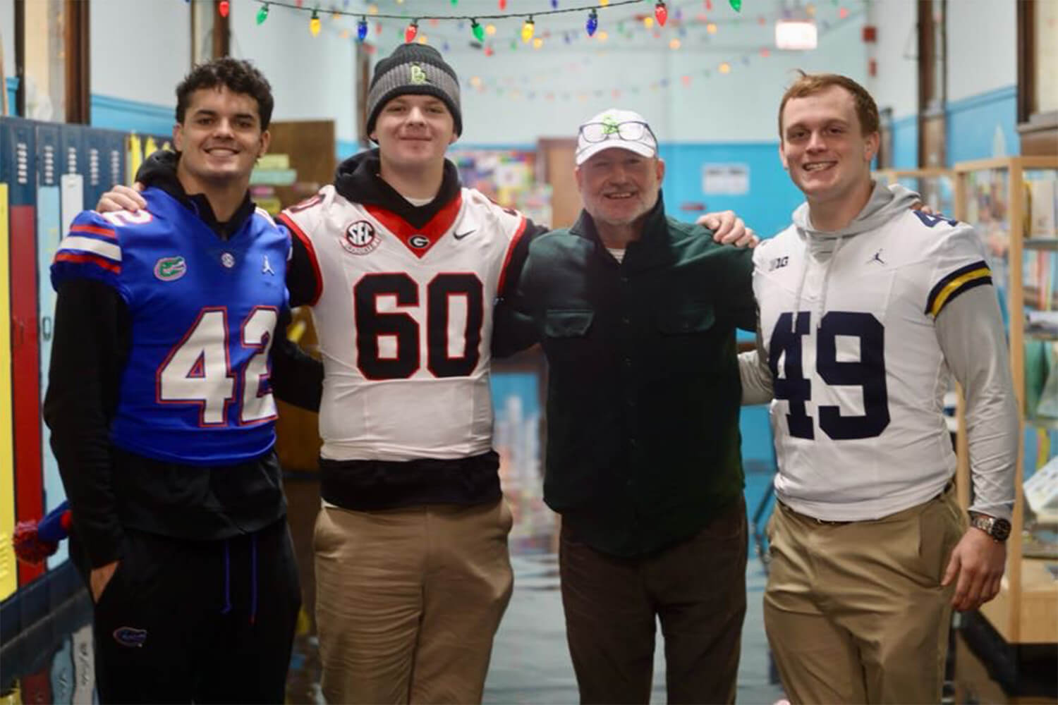 Group of football player posing for a photo with a man