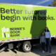 Elsie and her mom posing in front of the Bernie's Book Bank truck