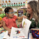Executive Director Amy Bott distributing books to a classroom